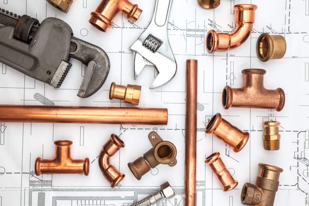 Old bathroom pipes may need to be replaced homeowner checking to see if you need to replace old pipes when remodeling bathroom in Pasadena