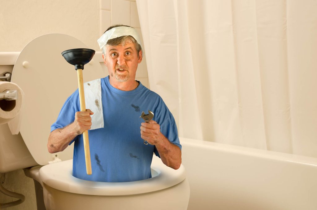 Pasadena, Maryland plumber holds plunger inside of running toilet